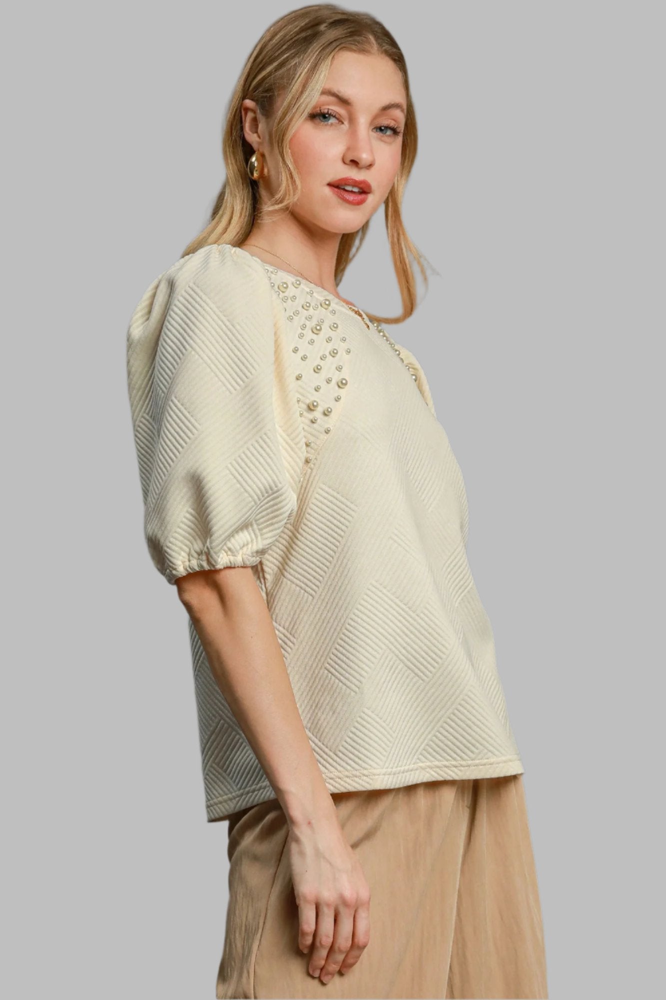 Cream knit puff-sleeve top with geometric textured pattern and pearl accents