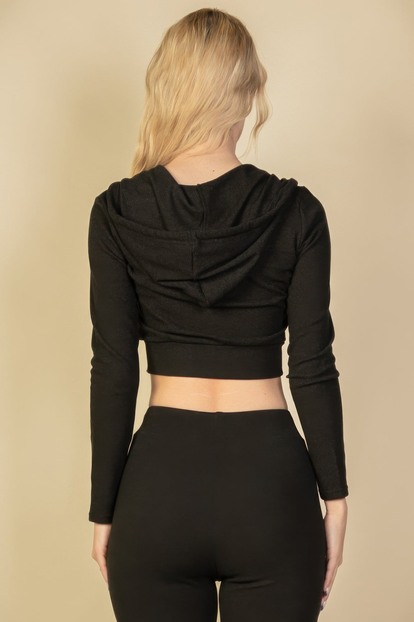 Black zip-up cropped hoodie back view with hood seams and drawstring ties