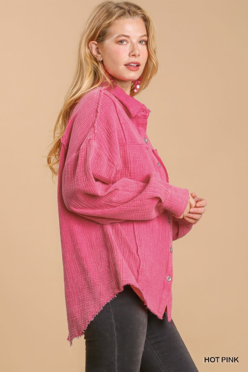 Hot pink button-down top with rolled sleeves and uneven high-low hem