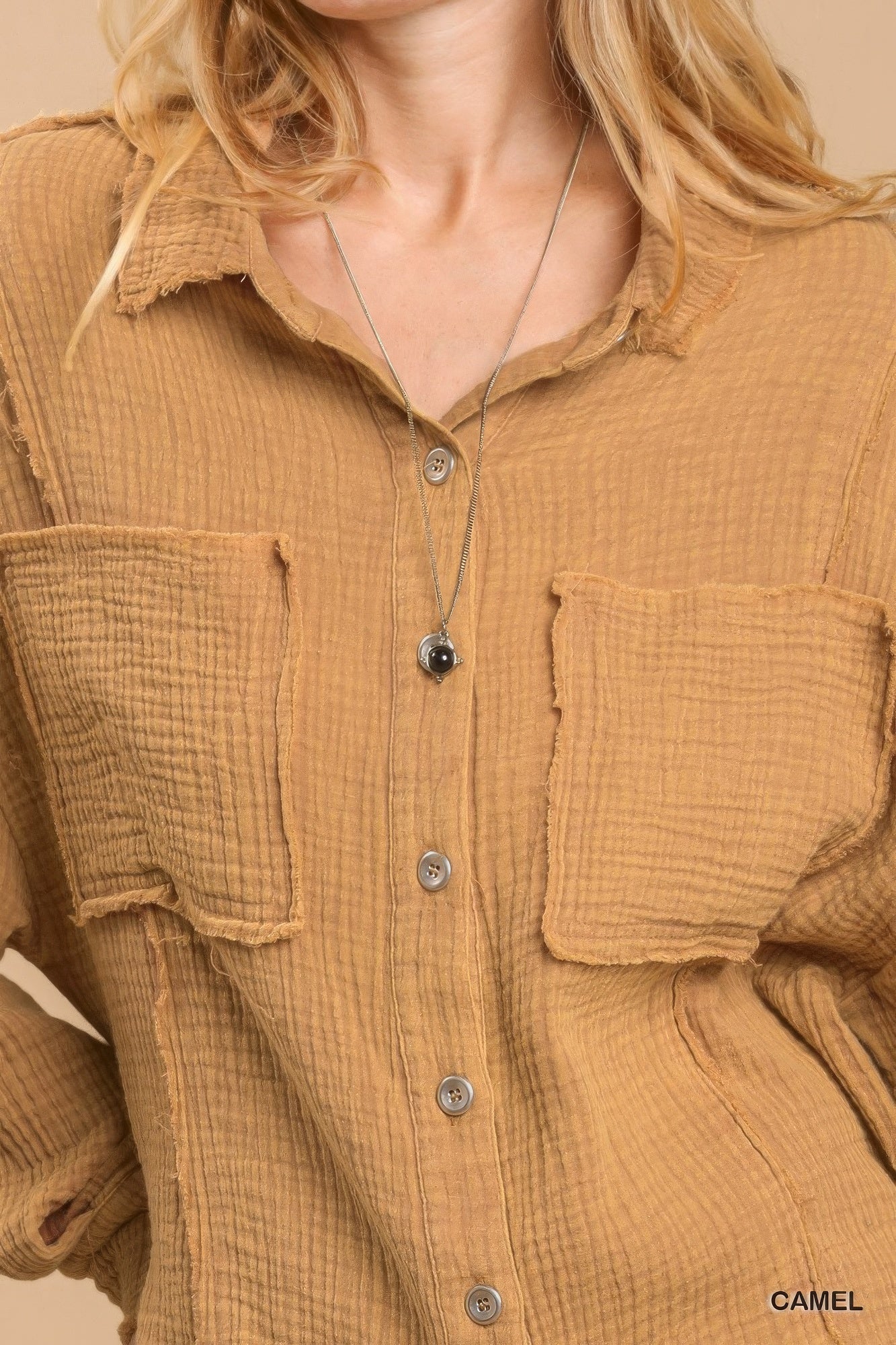 Camel button-down top close-up: two chest pockets and button front