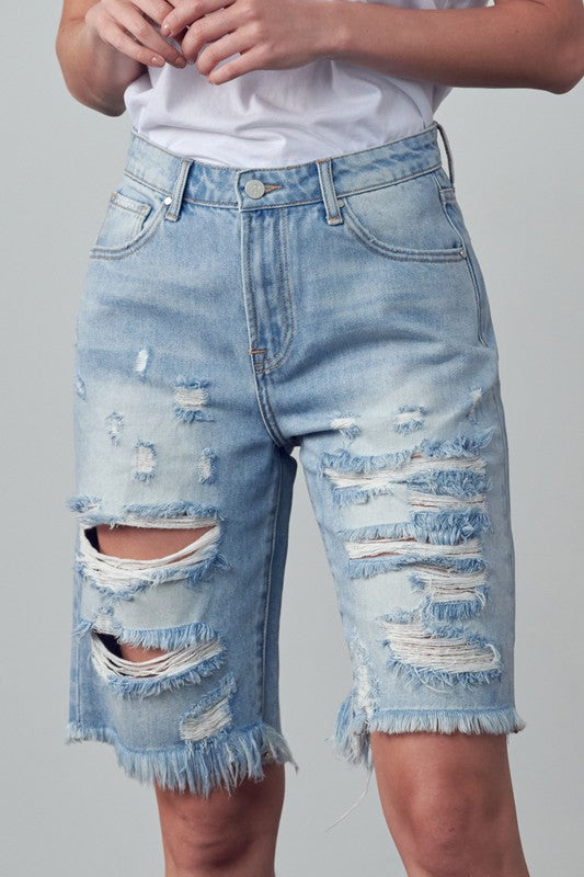 High-rise ripped denim bermuda shorts with large rips and frayed cuffs