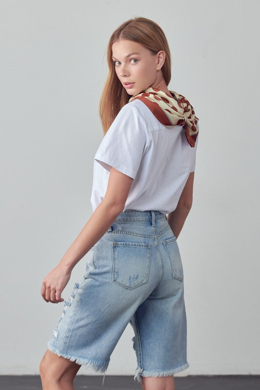High-rise ripped bermuda denim shorts, back view, light blue wash with frayed hem