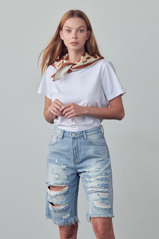 High-rise ripped denim bermuda shorts, front view, light blue wash with distressed rips
