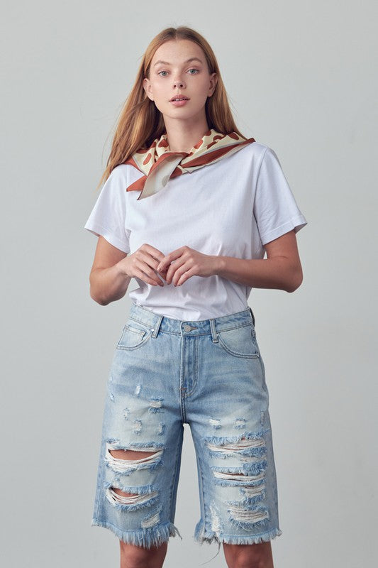 High-rise ripped bermuda denim shorts with frayed distressed legs, medium wash
