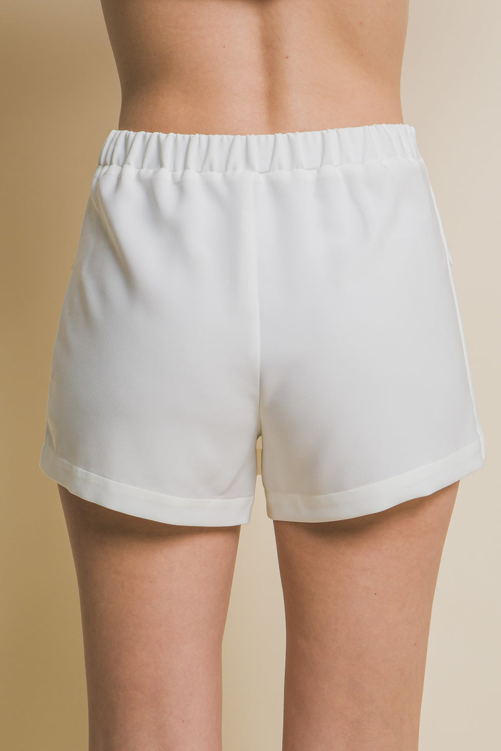 White skort back view with elastic waist and relaxed shorts fit