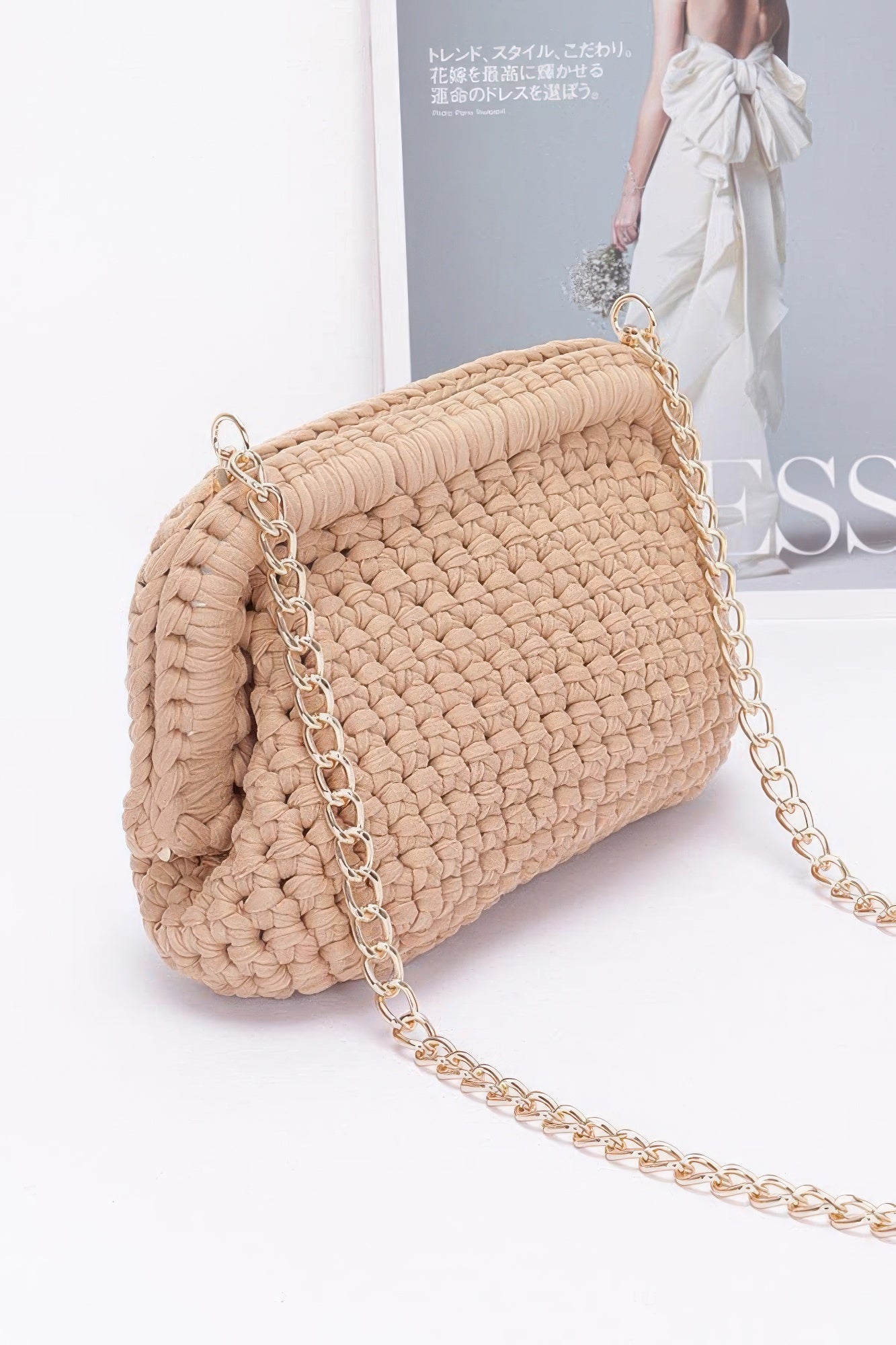 Beige braided cotton clutch bag with textured knit and gold chain handle