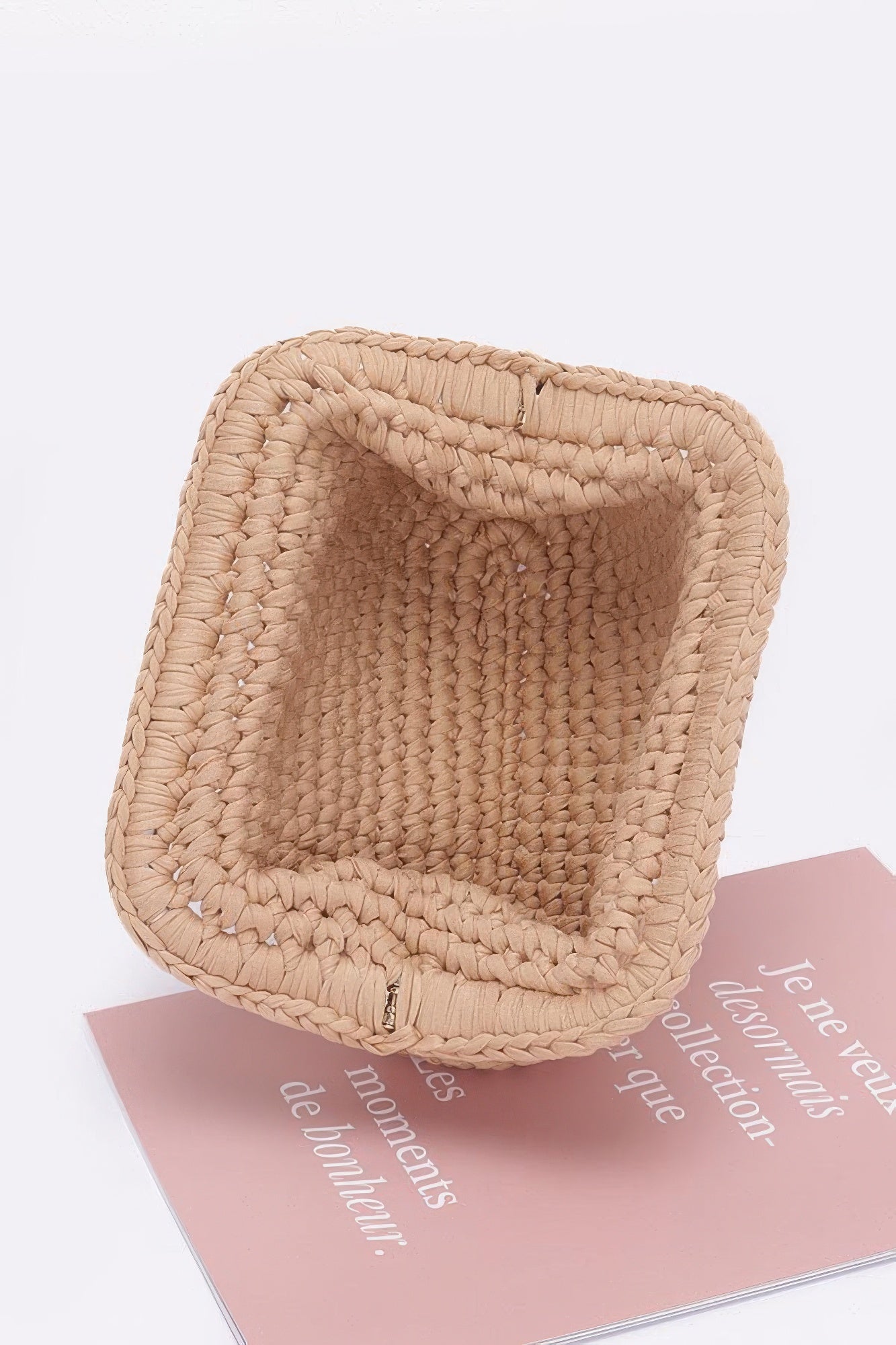 Beige braided cotton clutch with woven texture and open top interior