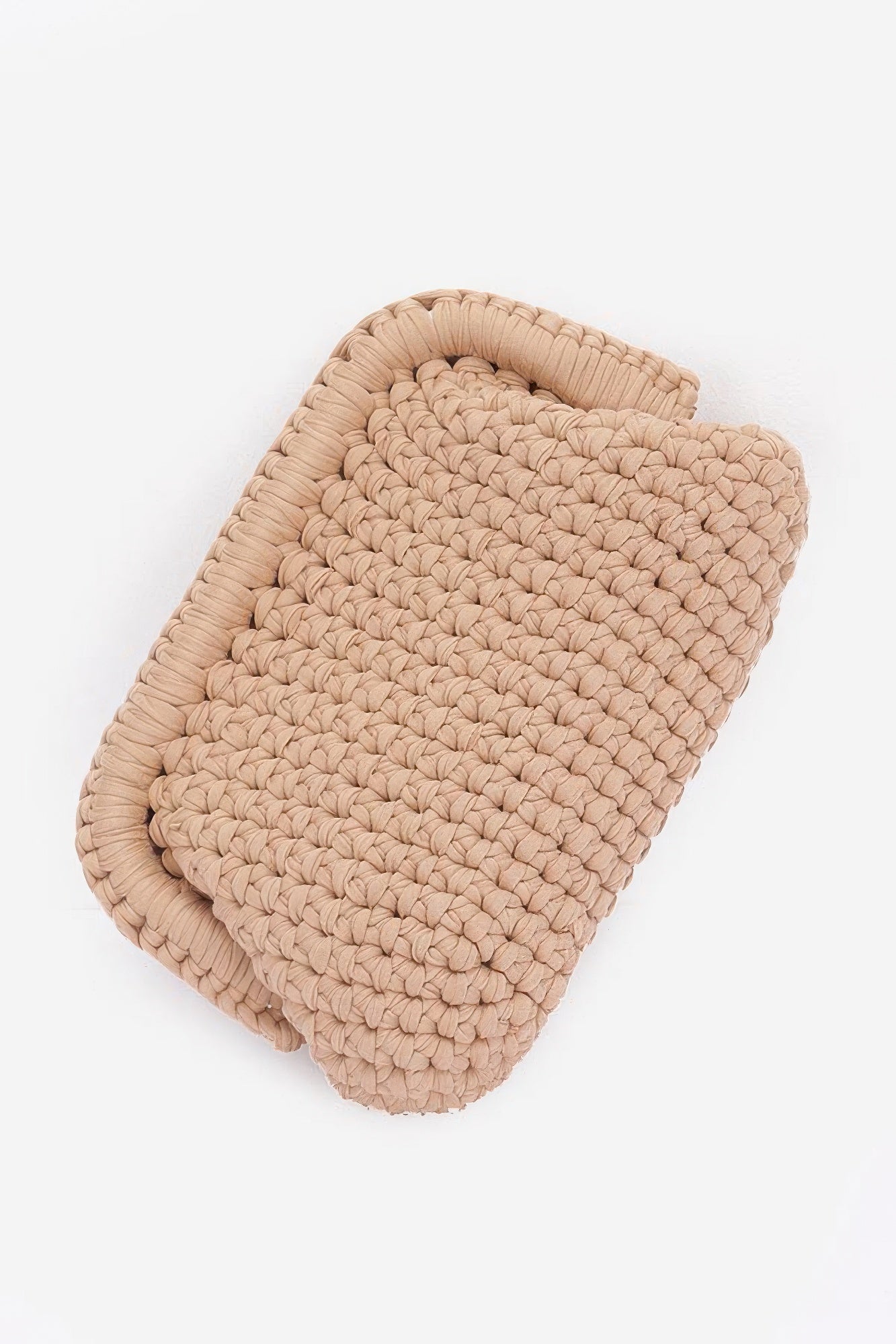 Beige cotton braided clutch with curved shape and thick woven rope texture