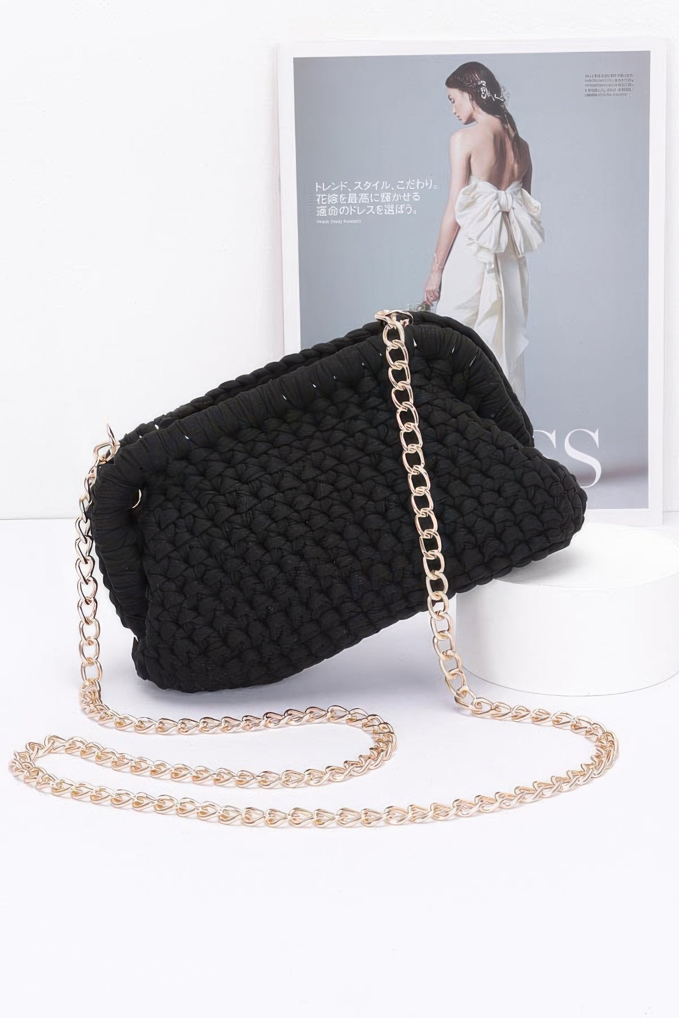 Black cotton braided clutch with gold-tone chain strap and braided woven texture