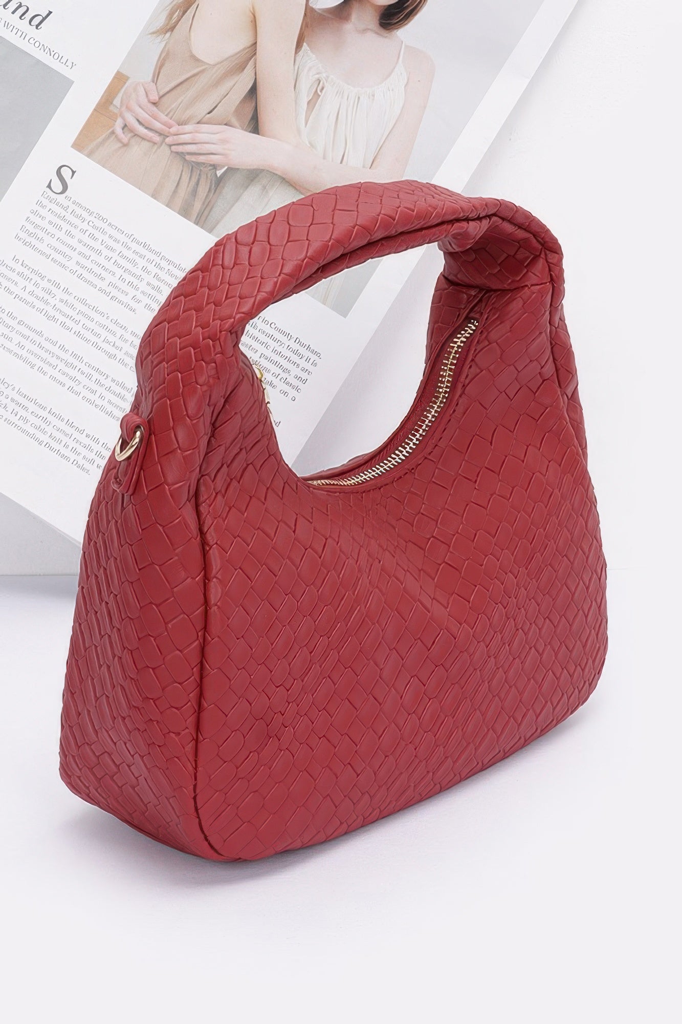 Burgundy embossed faux leather hobo bag from front angle with top zipper opening