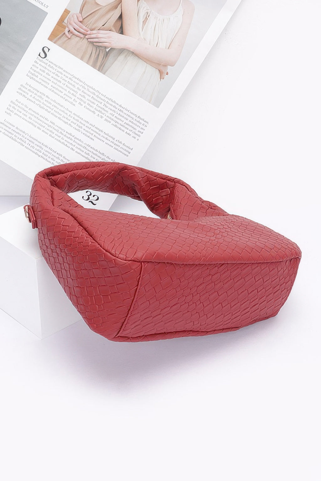 Burgundy embossed faux leather hobo bag with chain strap and angled side view