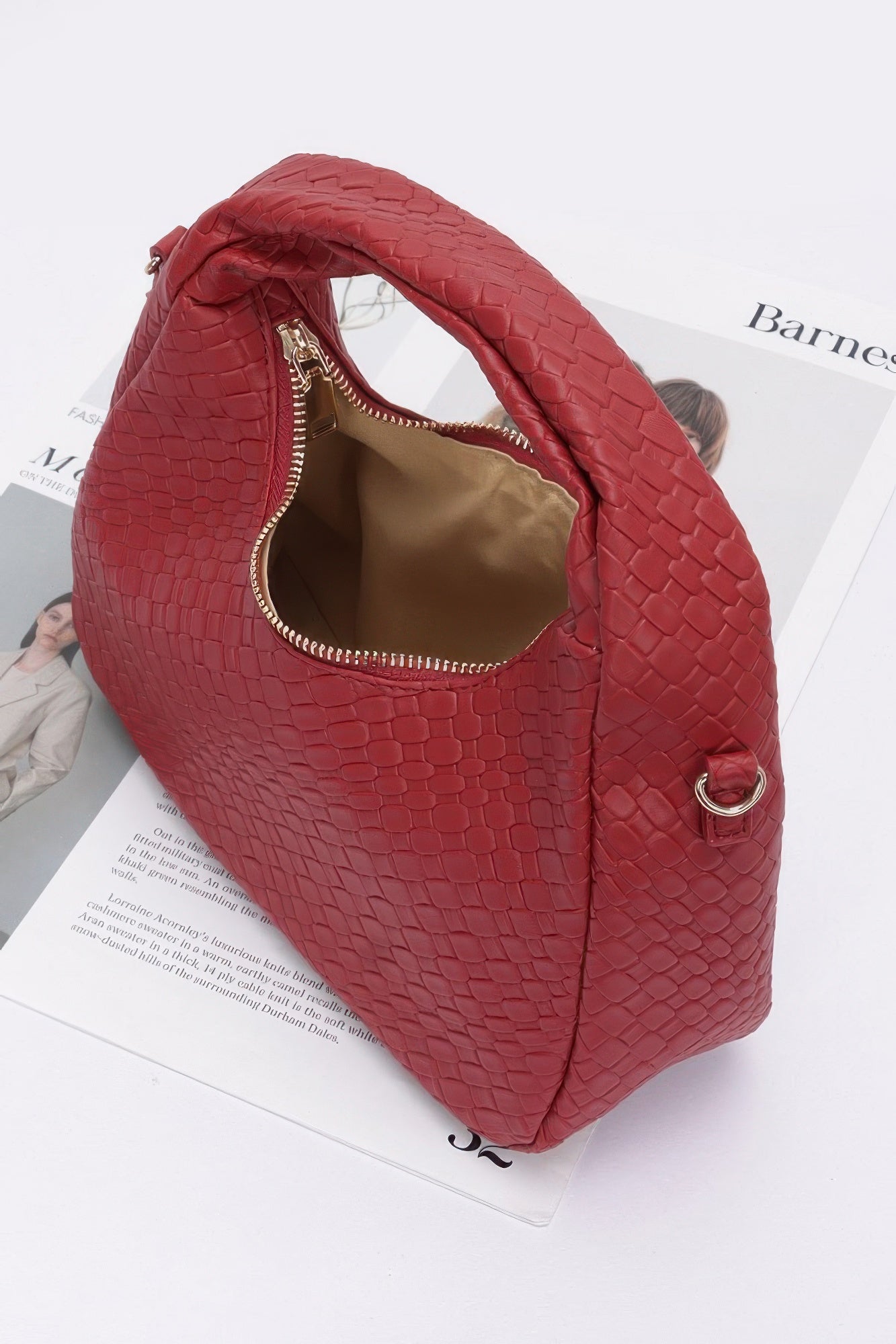 Burgundy embossed faux leather hobo bag with visible inner lining and gold zipper pull