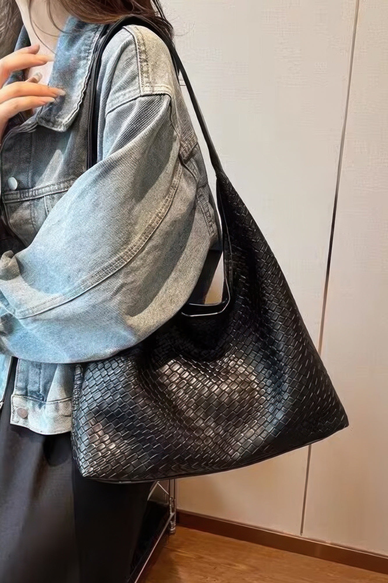 Embossed faux leather shoulder tote, black textured finish worn on shoulder