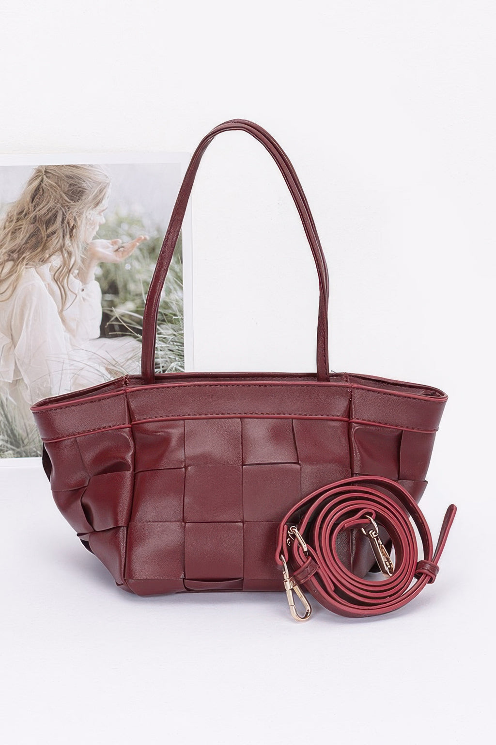 Burgundy faux leather braided tote bag with woven square panel design and top handles