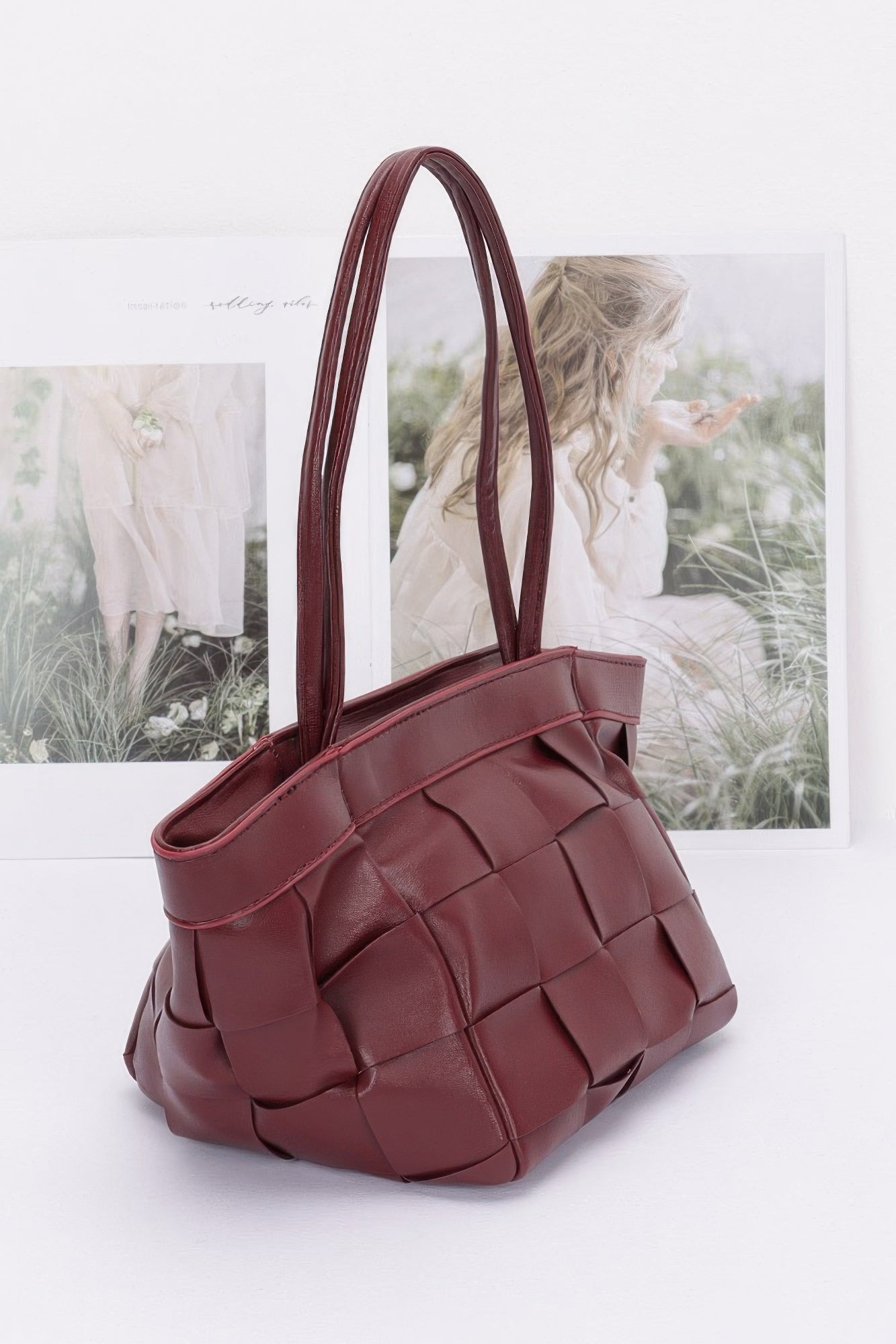 Burgundy faux leather braided tote bag with quilted woven square pattern and wide handles