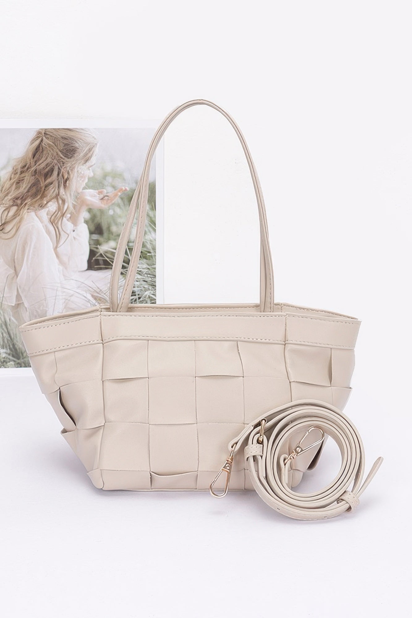 Light beige faux leather braided tote bag with woven square panels and braided crossbody strap