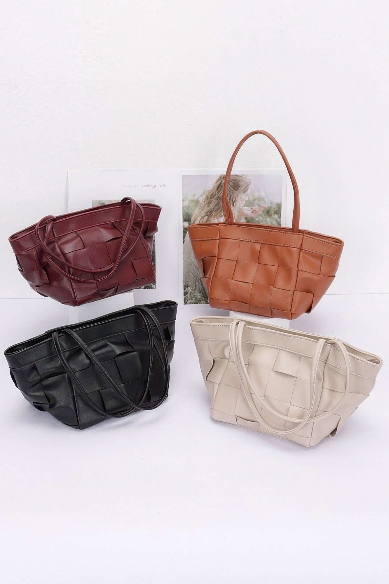 Four faux leather braided tote bags in burgundy, camel, black, and light beige