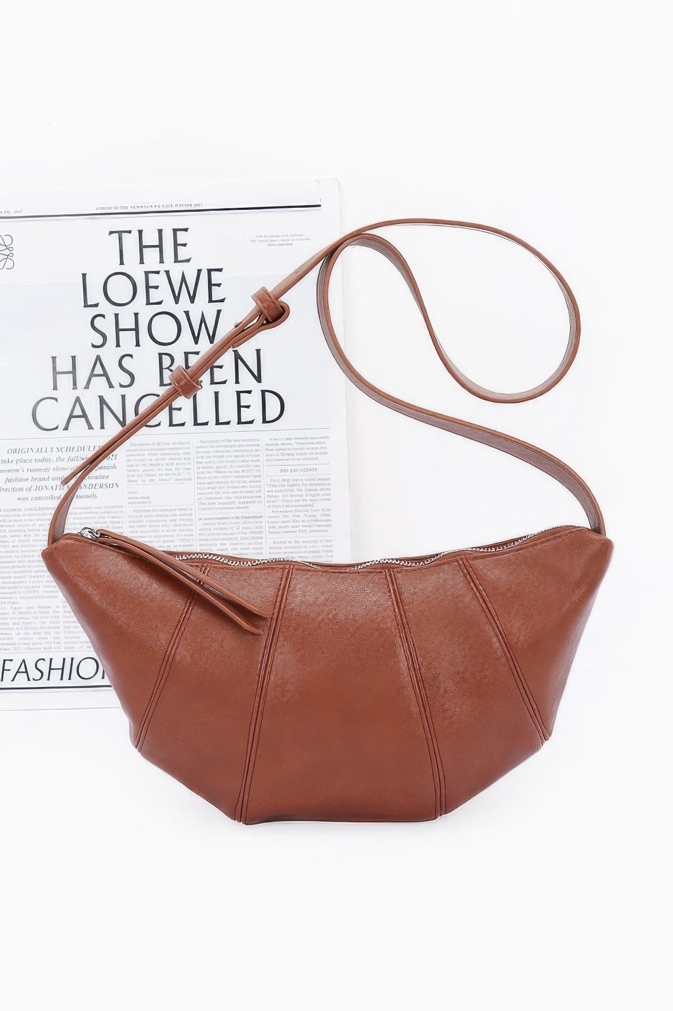 Brown faux leather croissant bag with zip-top and long crossbody strap