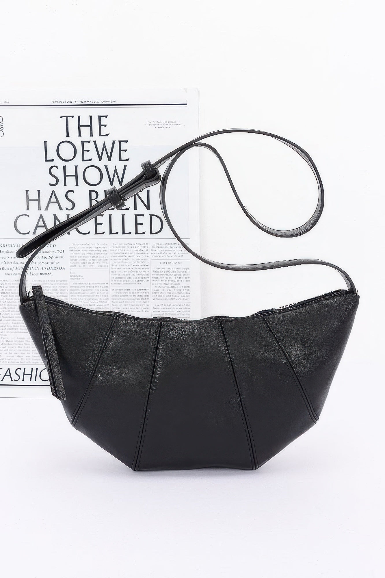 Black faux leather croissant bag with zip-top and long crossbody strap