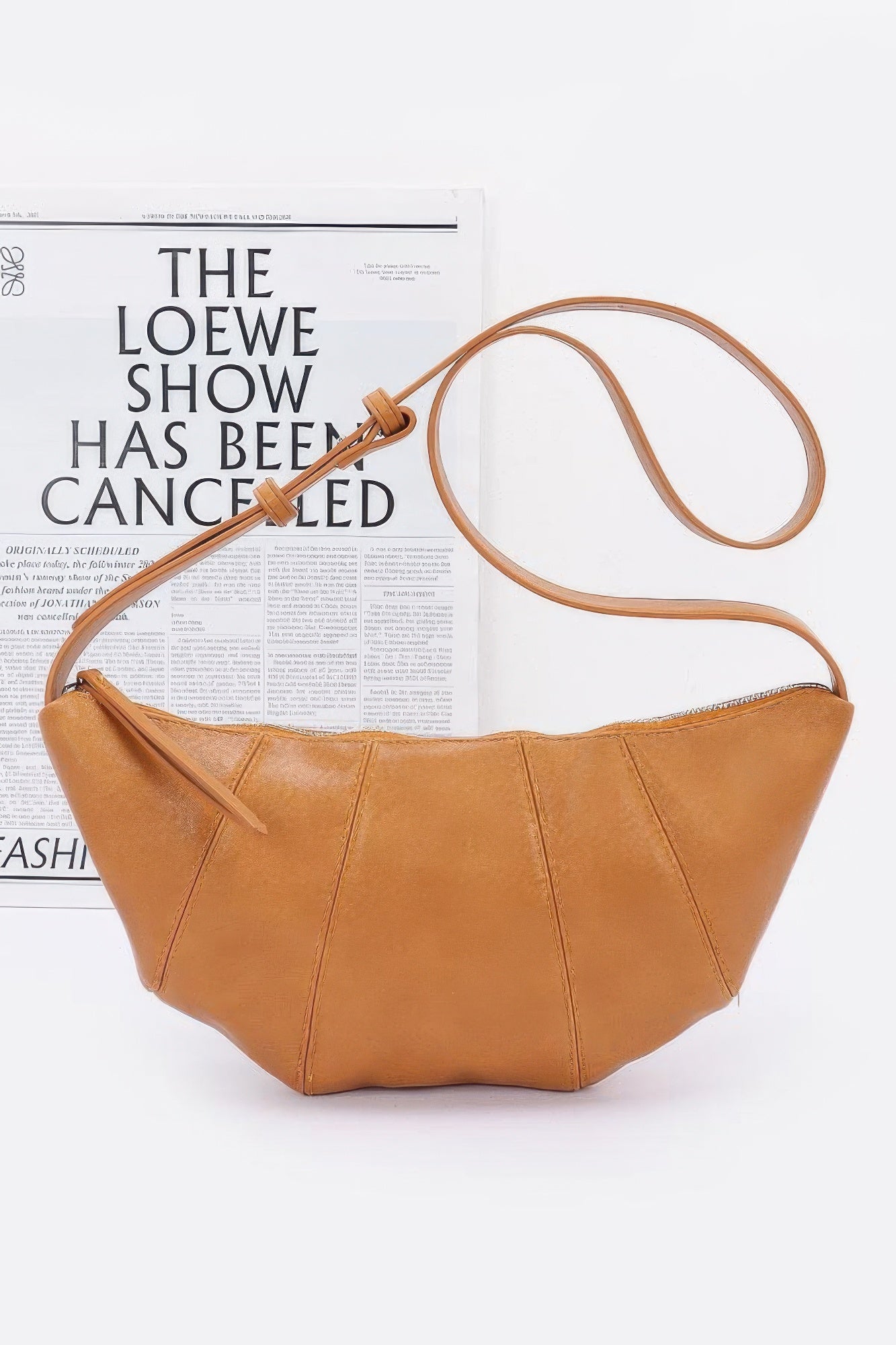 Mustard faux leather croissant bag with zip-top and long crossbody strap