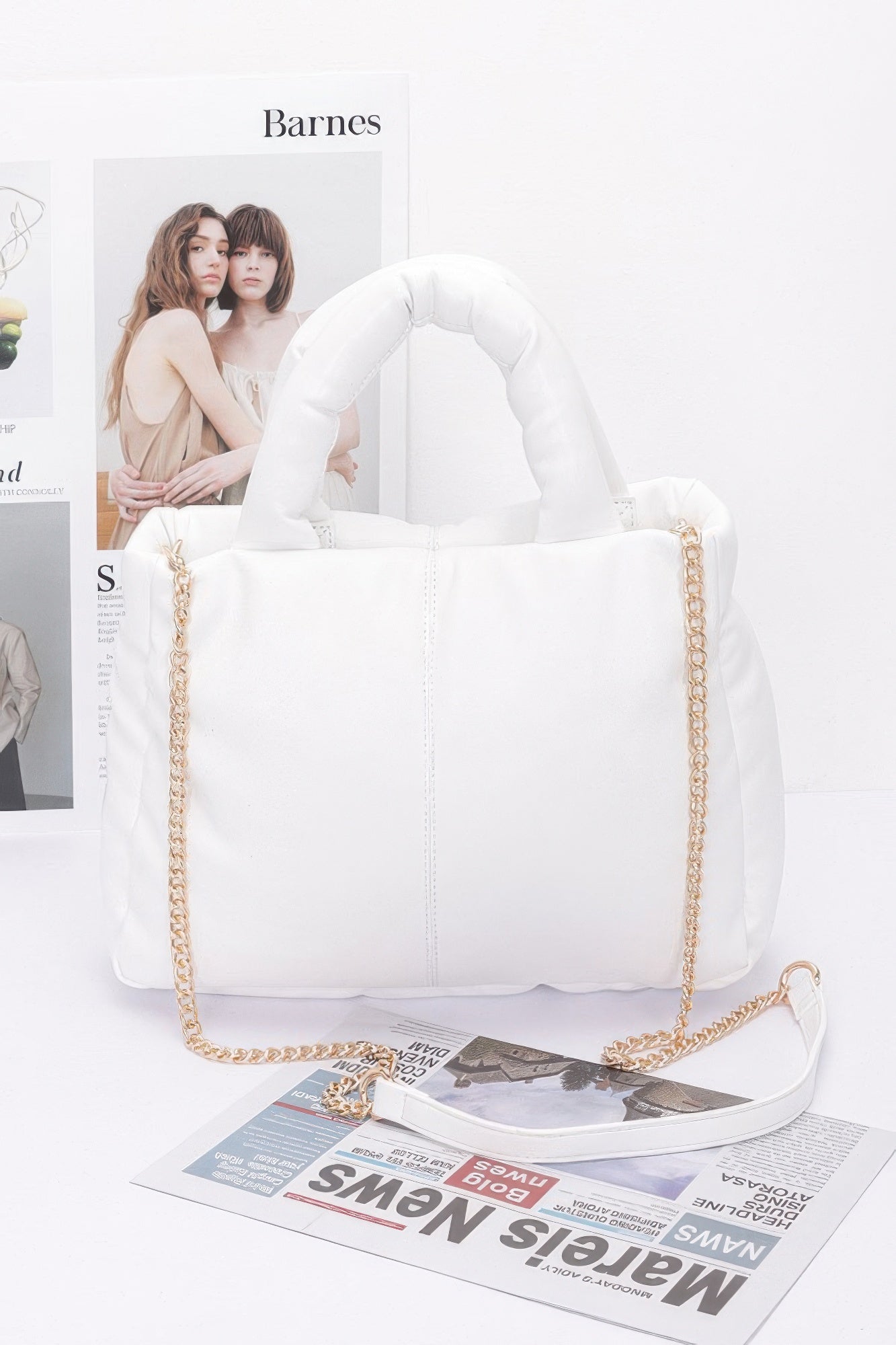 White faux leather padded tote bag with chain handles and top carry straps