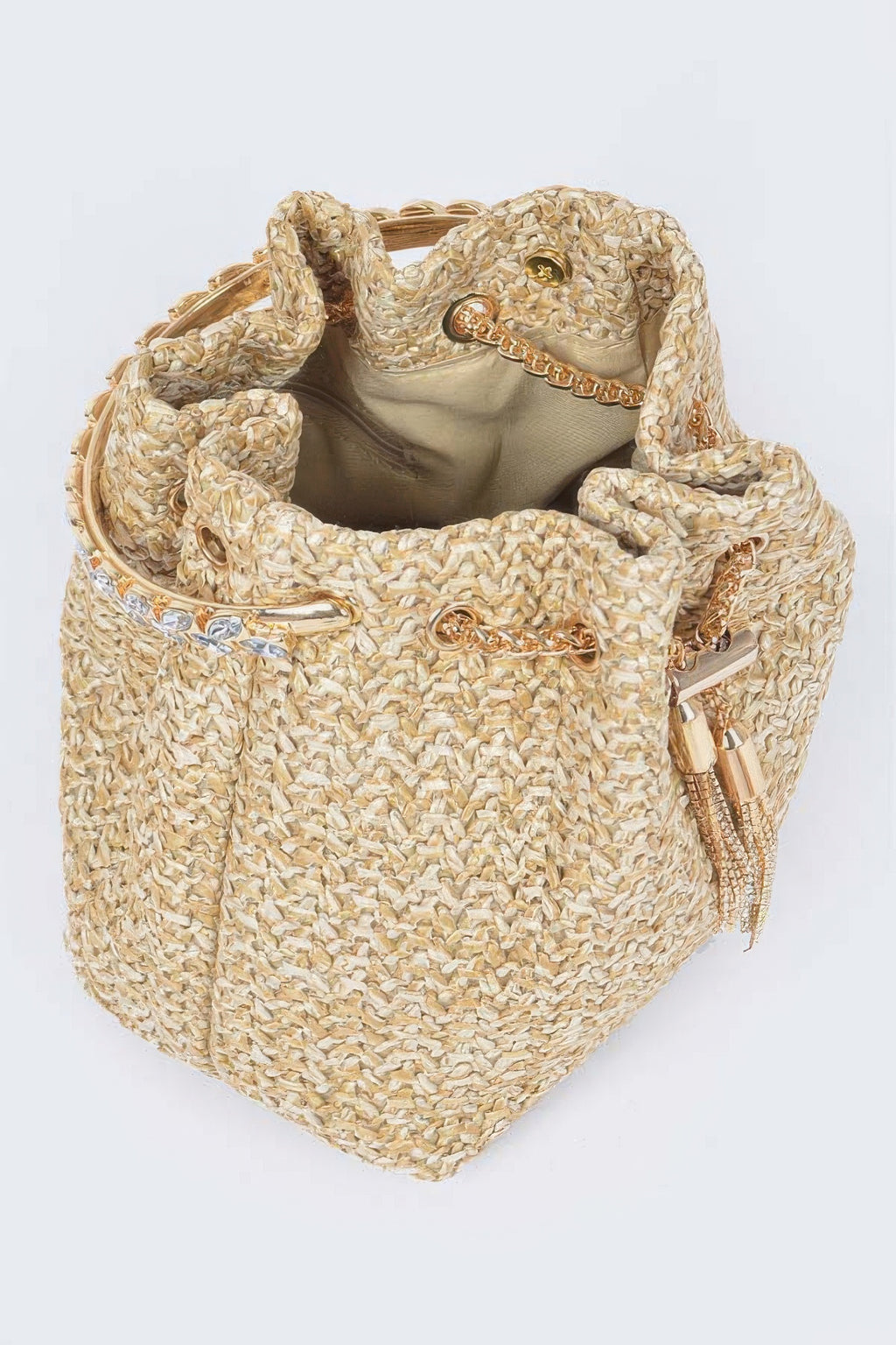 Interior view of faux straw bucket bag with fabric lining and gold chain