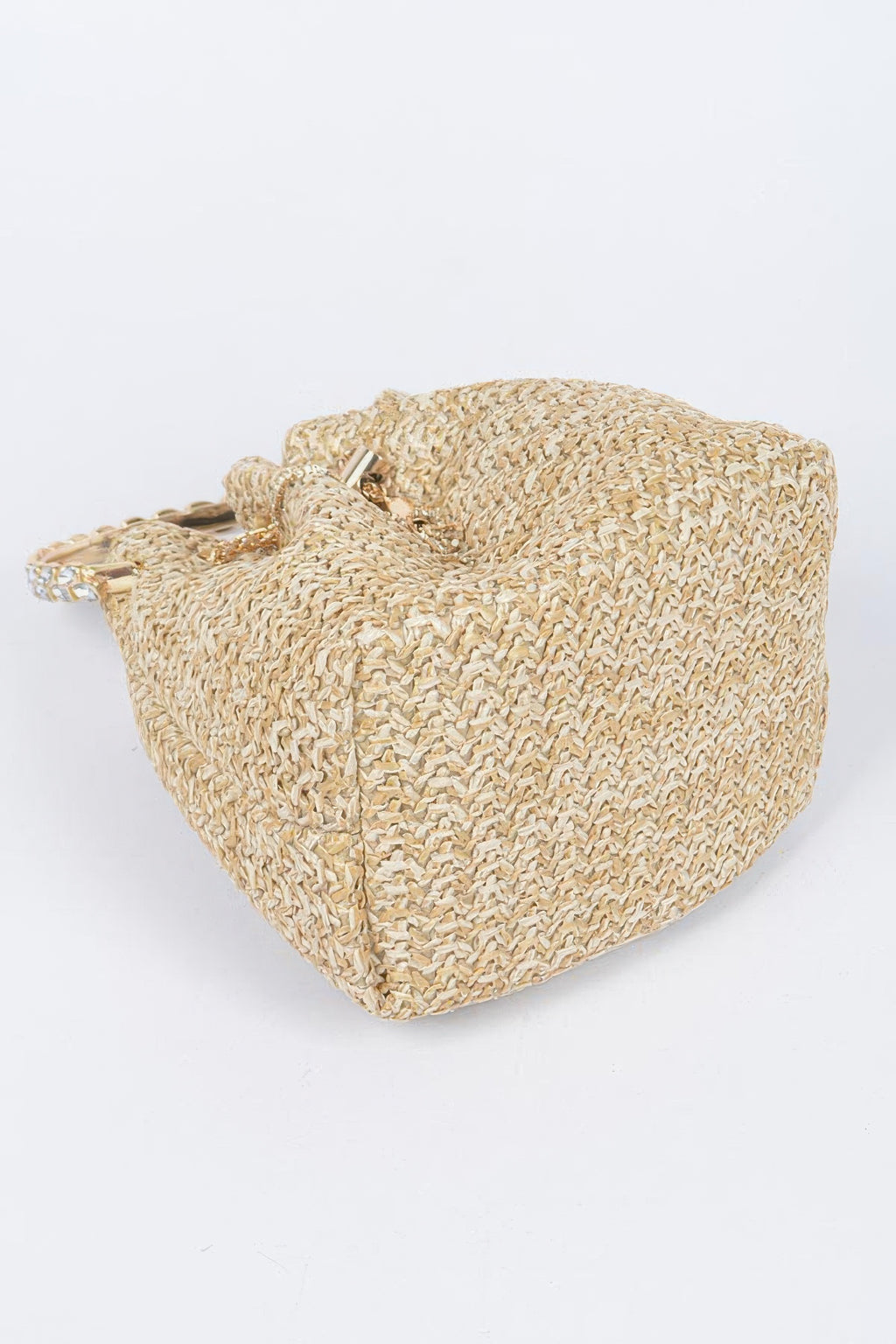 Faux straw bucket bag in natural tones, front pocket seam and zipper pull