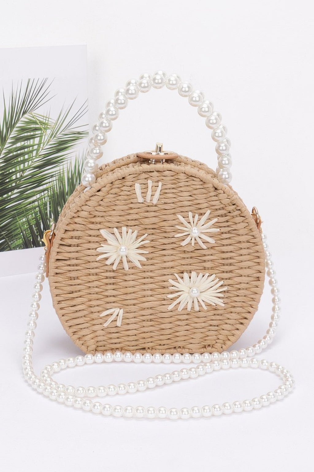 Faux straw clutch with pearl handle, round top clasp, white flower appliqués, khaki
