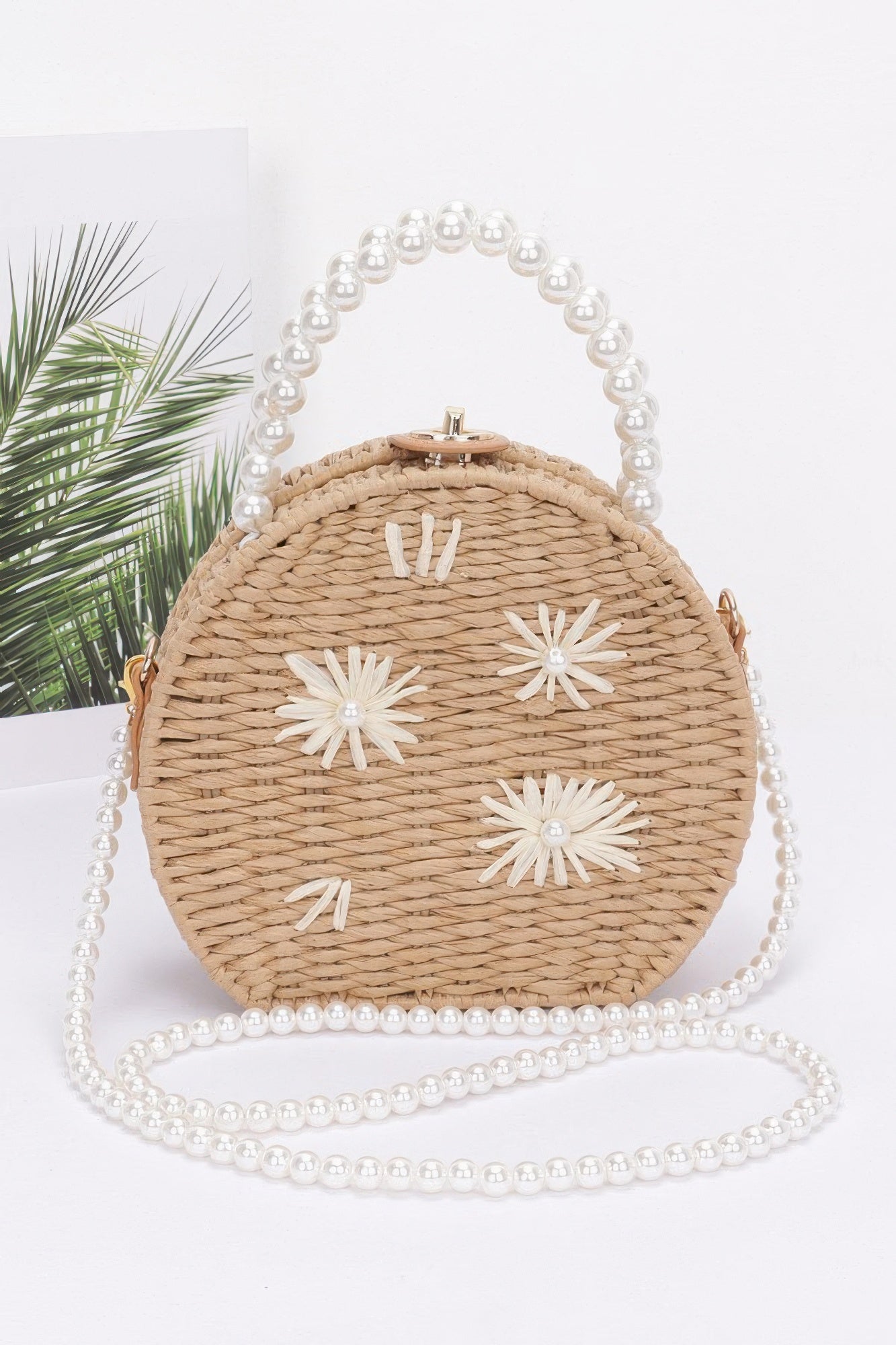Faux straw clutch with pearl handle, round top clasp, white flower appliqués, khaki
