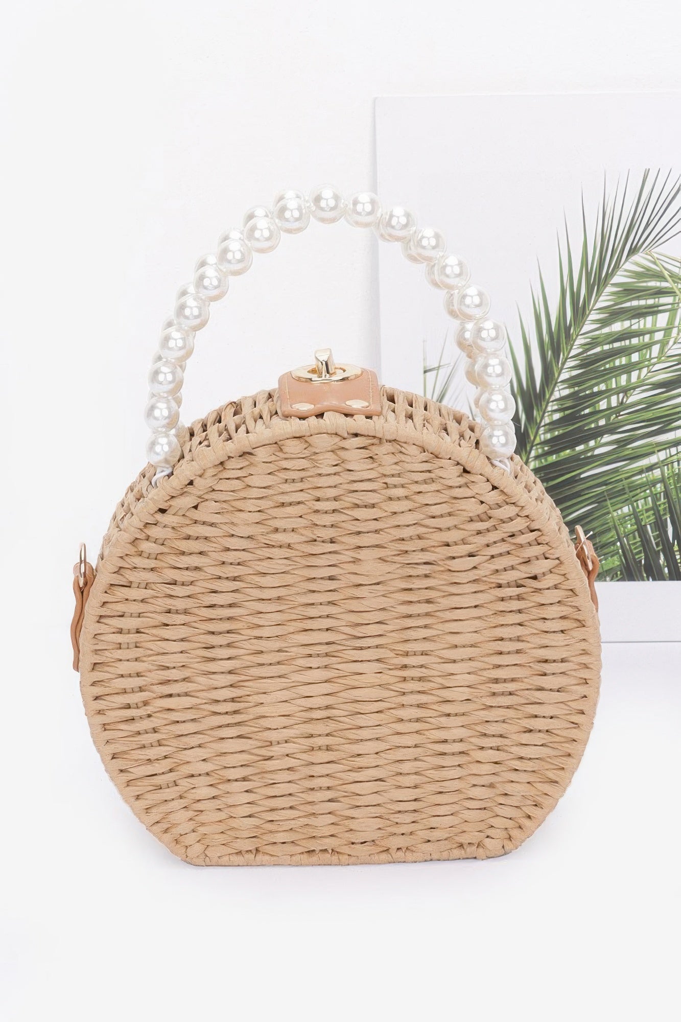Round faux straw clutch with top clasp and pearl handle, smooth woven body, khaki