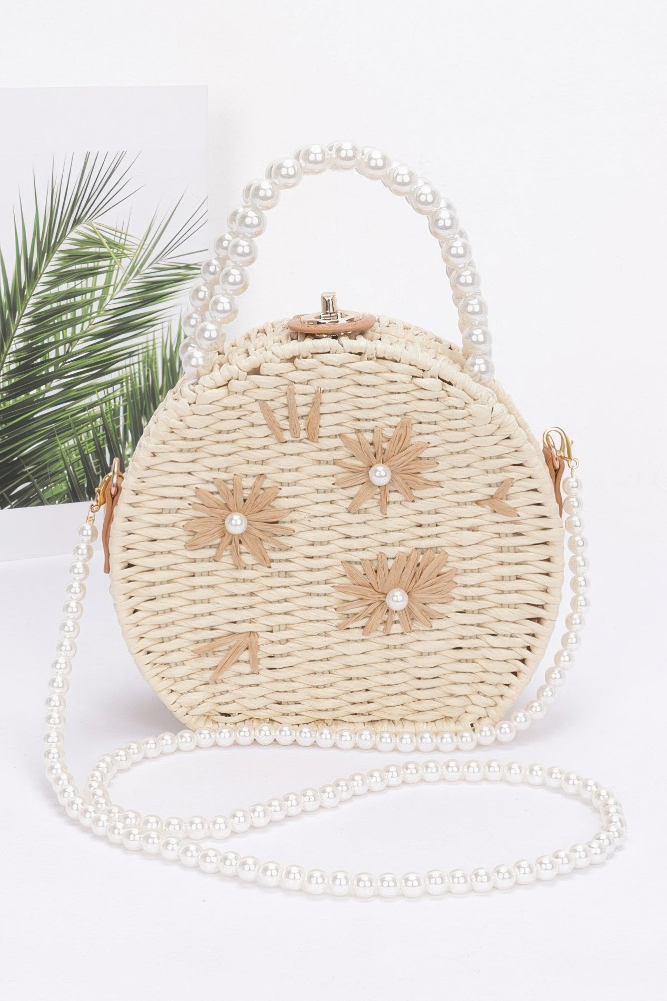 Faux straw clutch with pearl handle, round top clasp, white flower appliqués, ivory