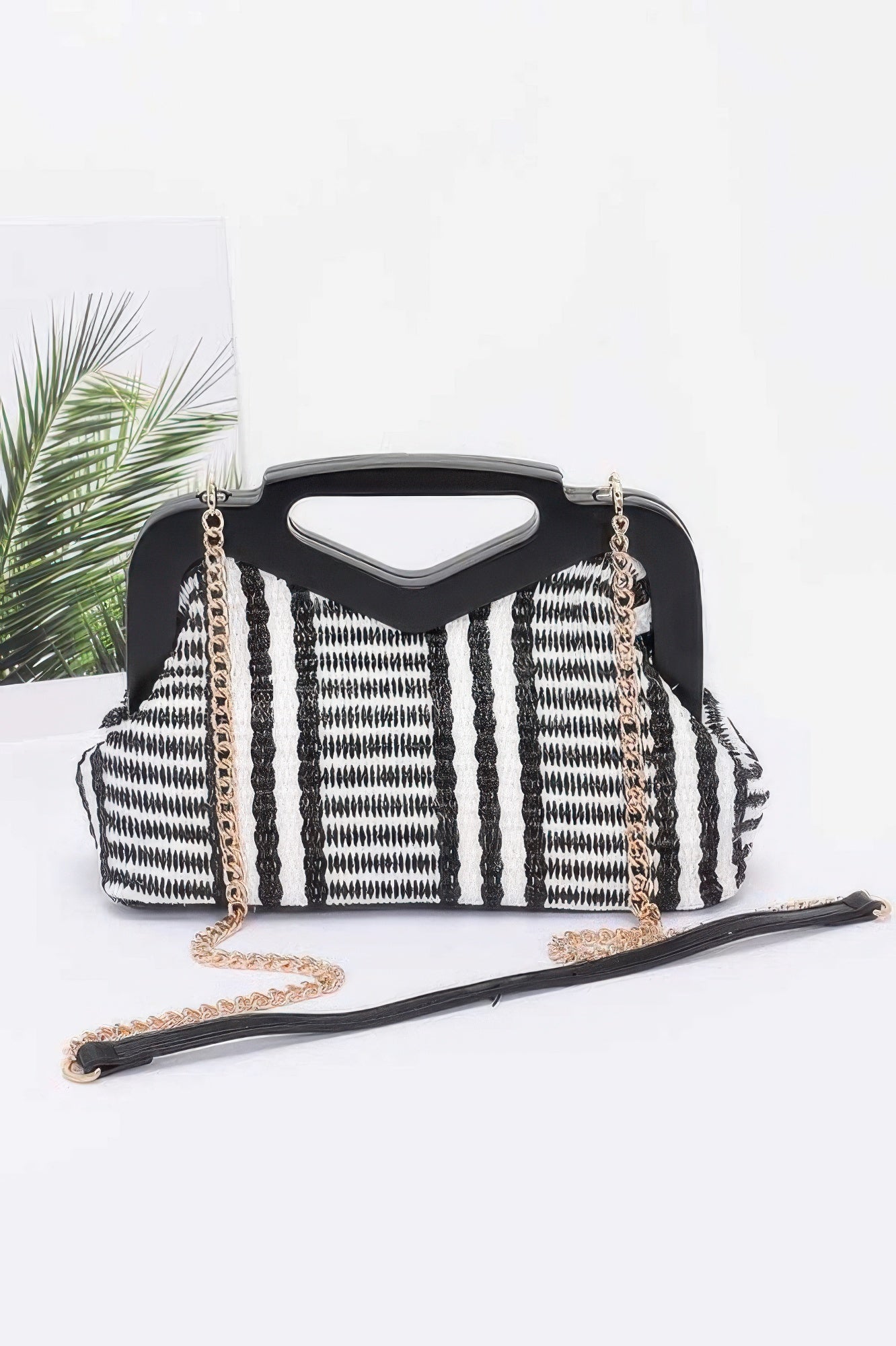 Faux straw clutch with wood-style frame, black-and-white striped front, gold chain strap
