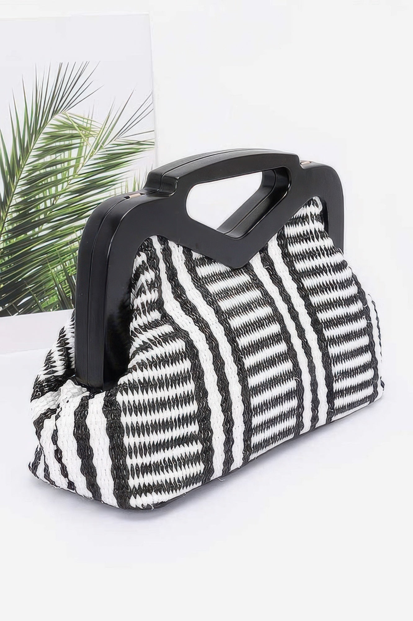 Black faux straw clutch with wood-style frame, zebra-striped front, wide woven top handle