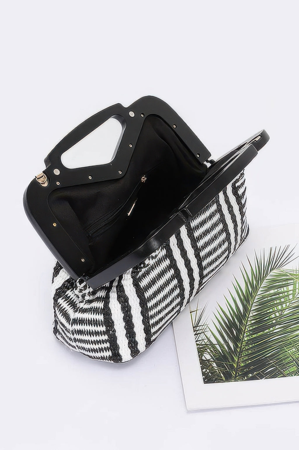 Black faux straw clutch with wood-style frame interior, zebra-striped body, gold chain