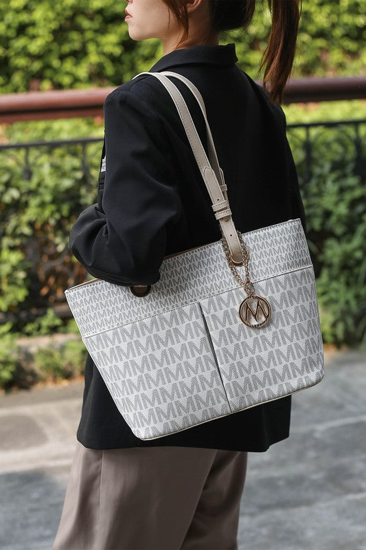 Lori printed tote bag in white with black M-pattern, gray straps, round logo charm