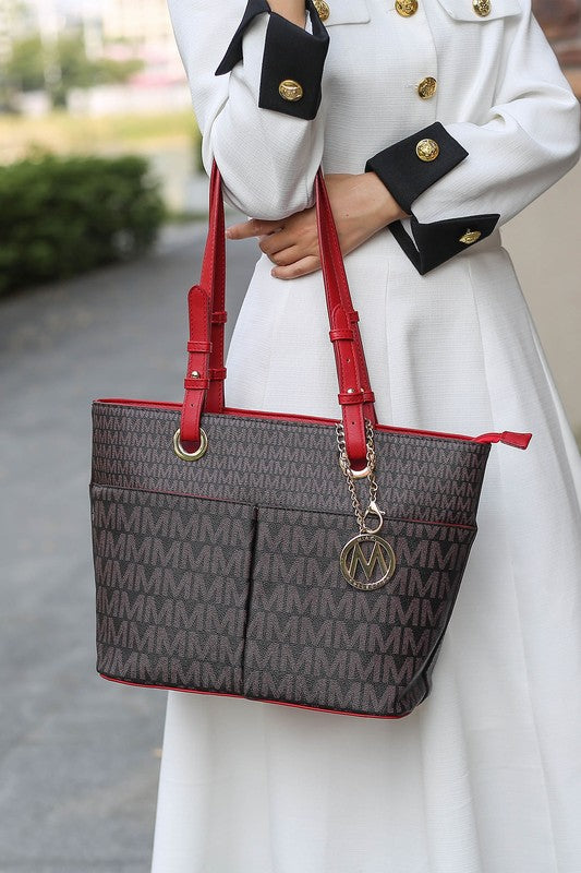Lori printed tote bag in dark brown with red trim and red handles, logo charm
