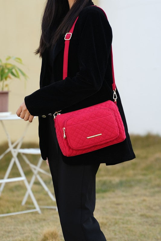 Fuchsia quilted shoulder bag with front zip pocket and gold-tone hardware