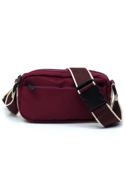 Nylon crossbody fanny pack in deep purple with front zip and adjustable strap