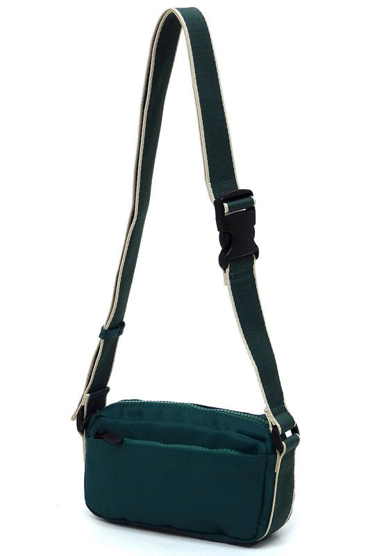 Green nylon crossbody fanny pack with adjustable strap and front zip pocket