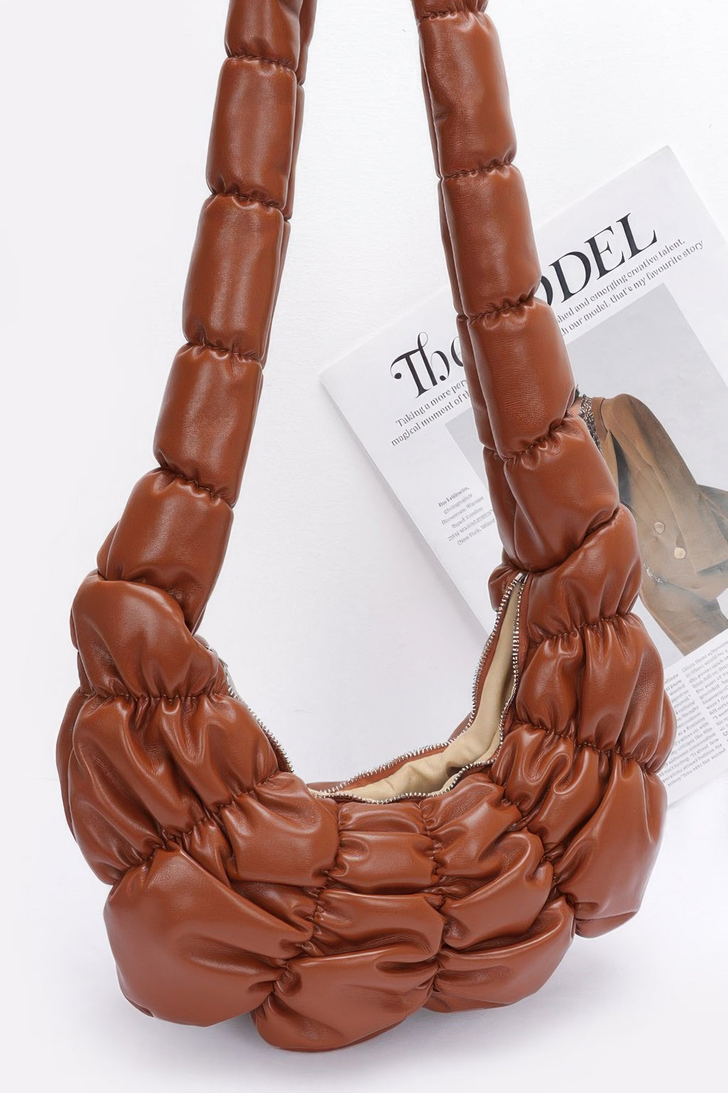 Pleated faux leather crossbody bag, brown, close-up of ruched top and interior lining