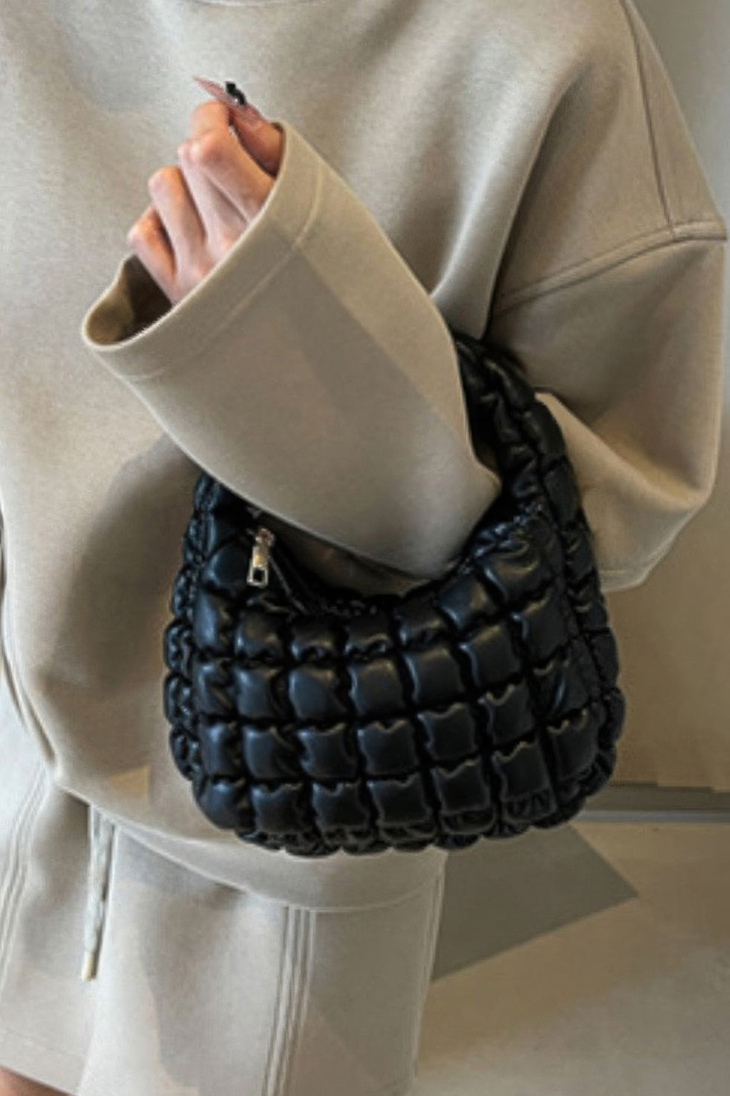 Quilted faux leather padded handle bag, dark with chain strap.