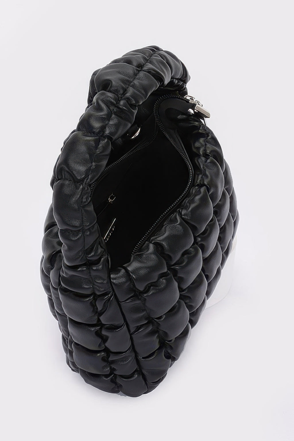 Quilted faux leather padded handle bag, black, back view with zipper pocket.