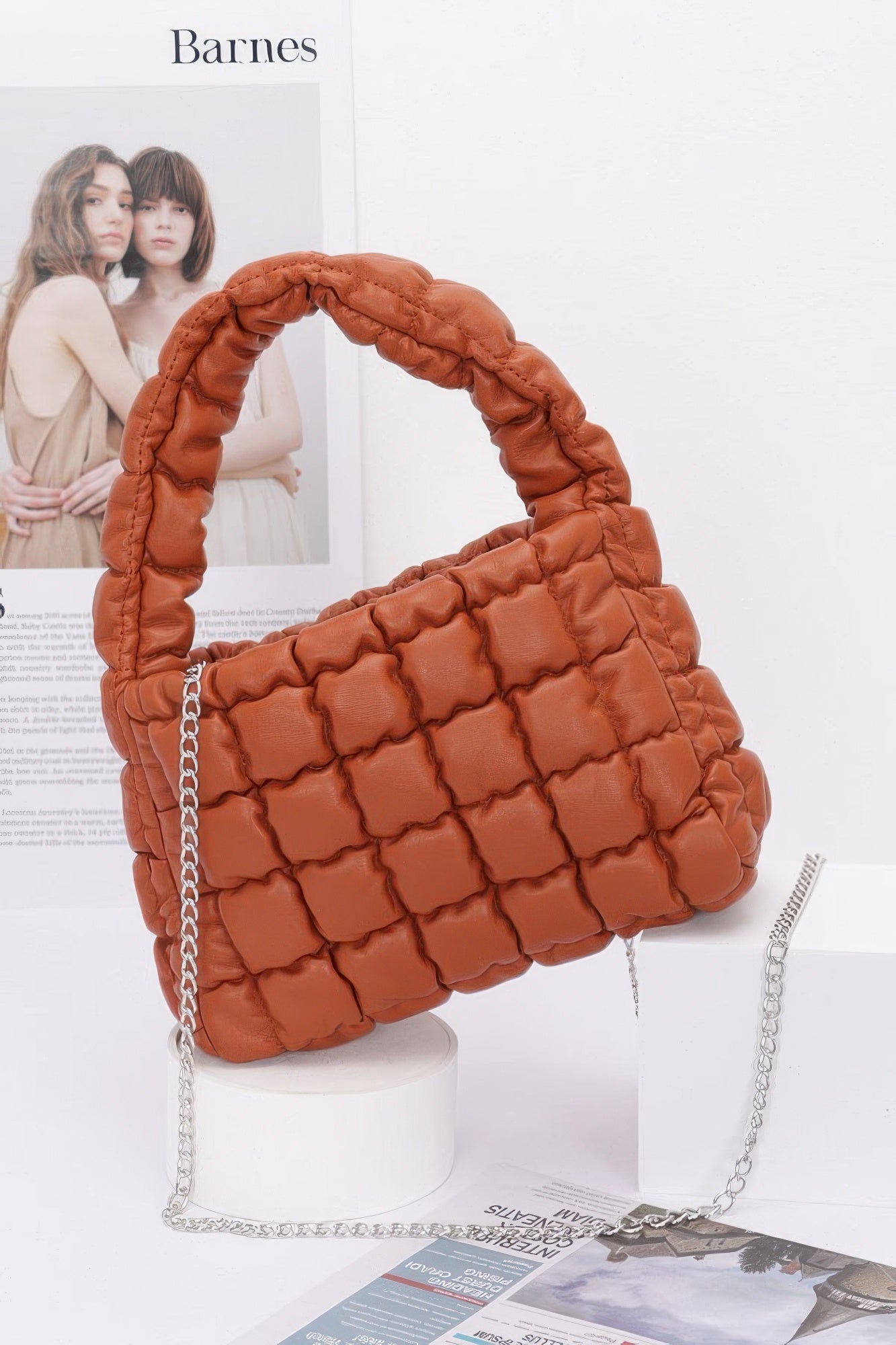 Quilted faux leather padded handle bag with chain strap, rust brown.