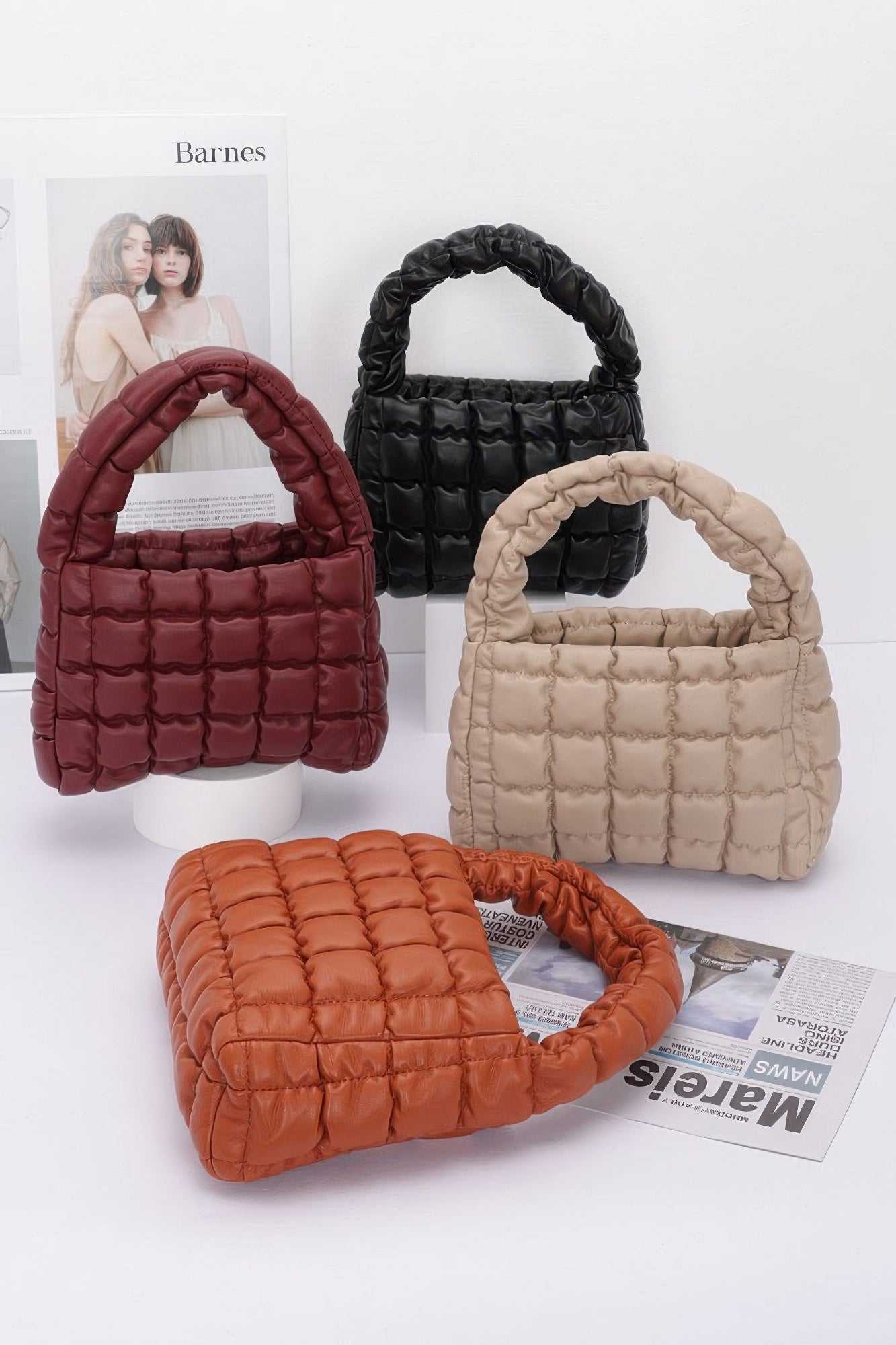 Quilted faux leather padded handle bags in burgundy, black, beige, and orange.
