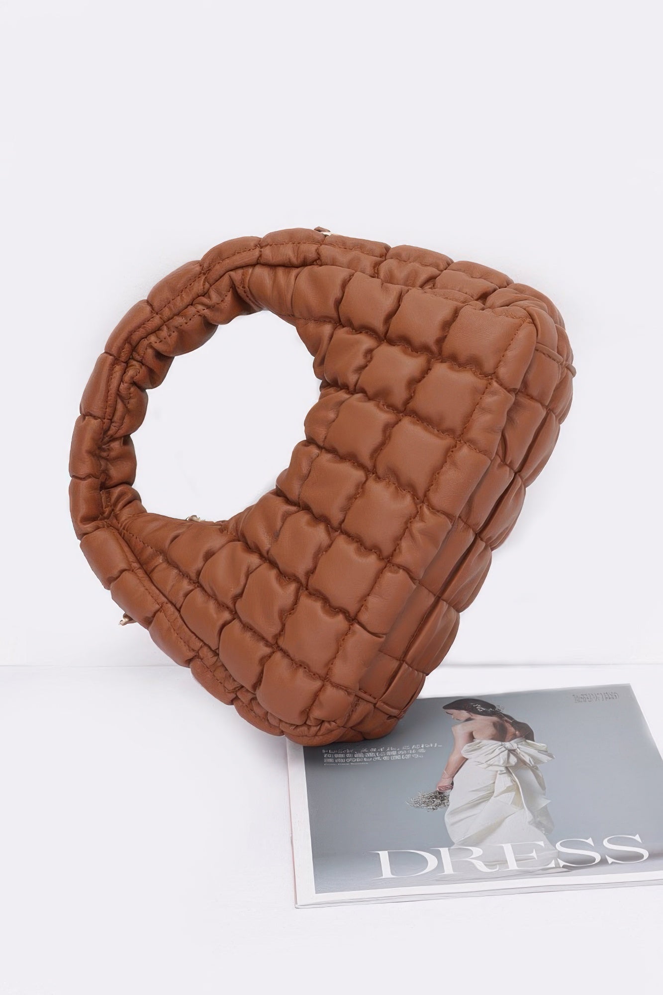 Camel quilted faux leather hobo bag with padded ring handle and structured side panels