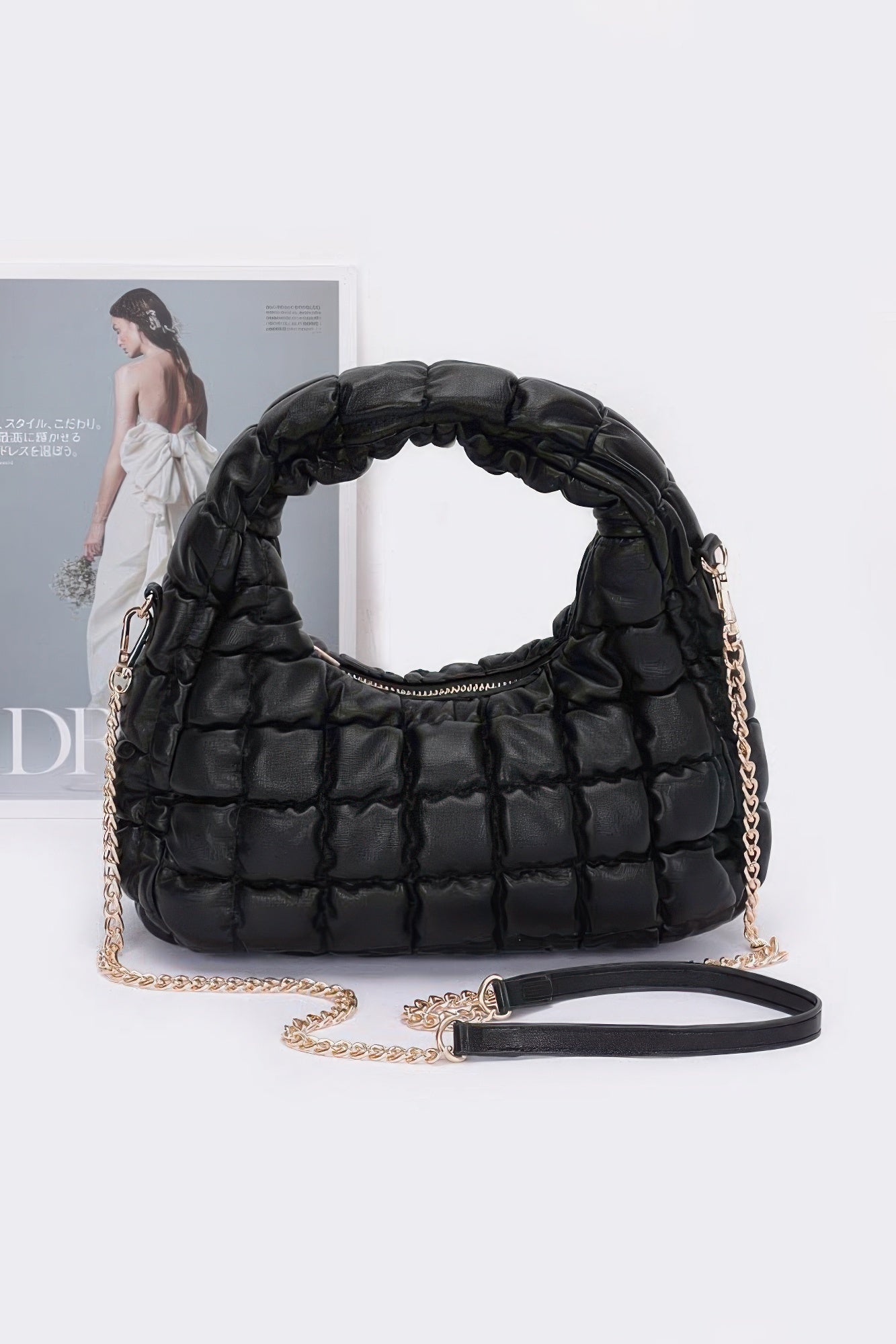 Black quilted faux leather padded hobo bag with chain shoulder strap and zipper top