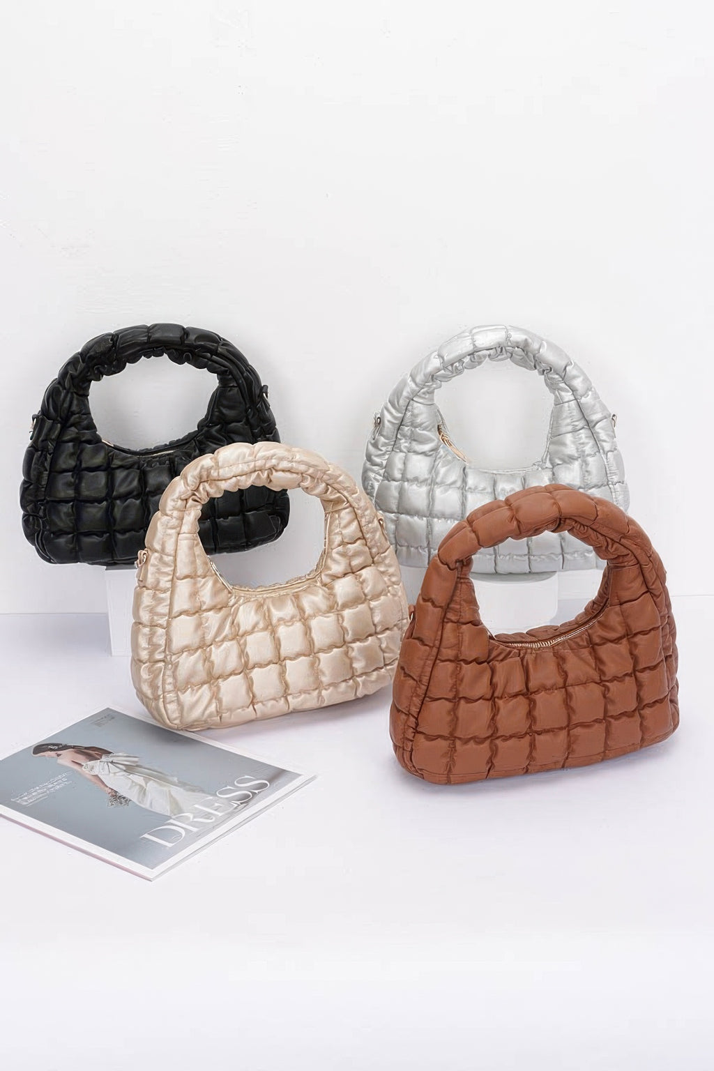 Set of quilted faux leather hobo bags in black, cream, silver, and camel-brown tones