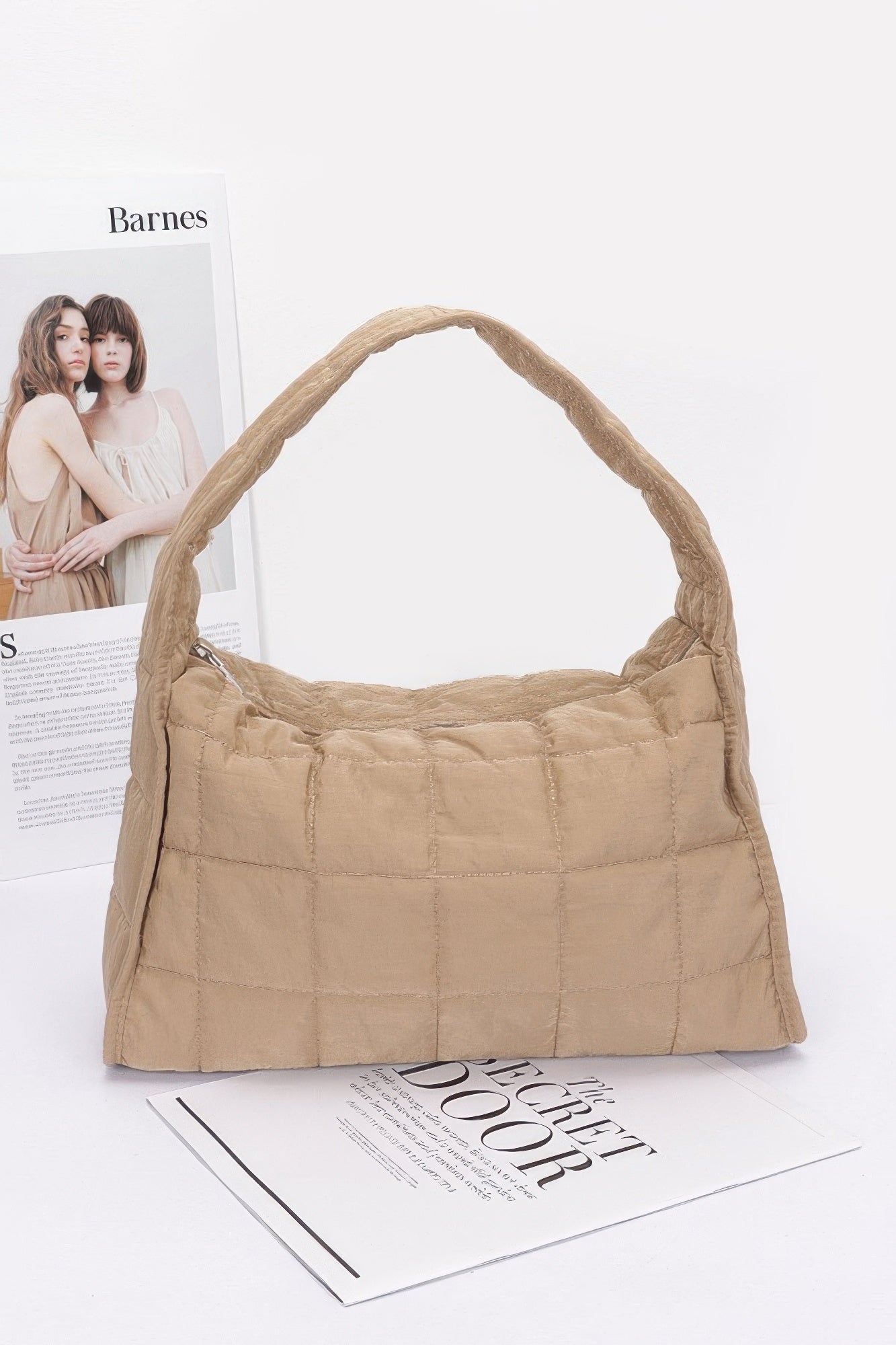 Quilted nylon shoulder bag in khaki with curved handle and quilted grid stitching