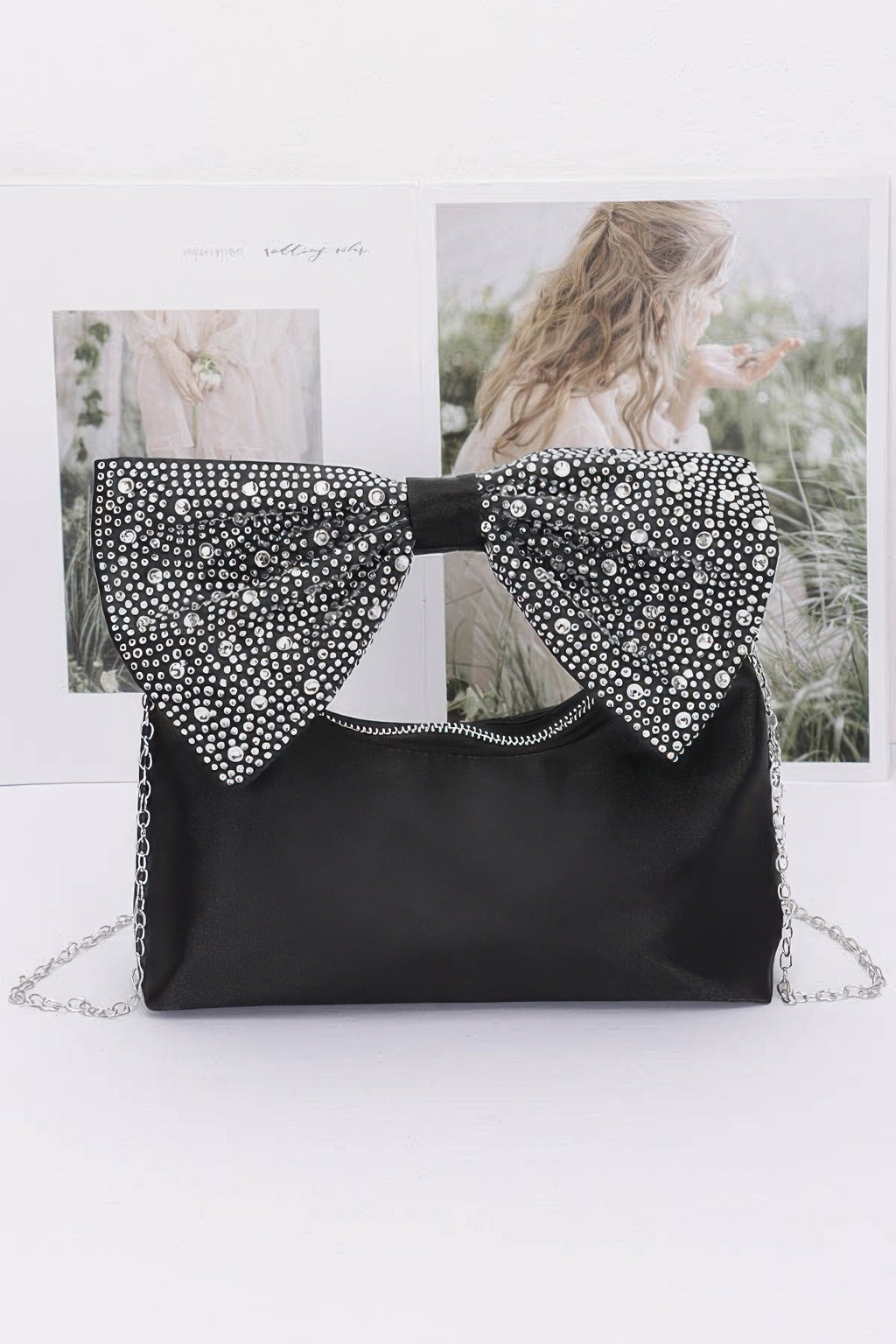 Black nylon clutch with rhinestone bow handle and silver chain strap