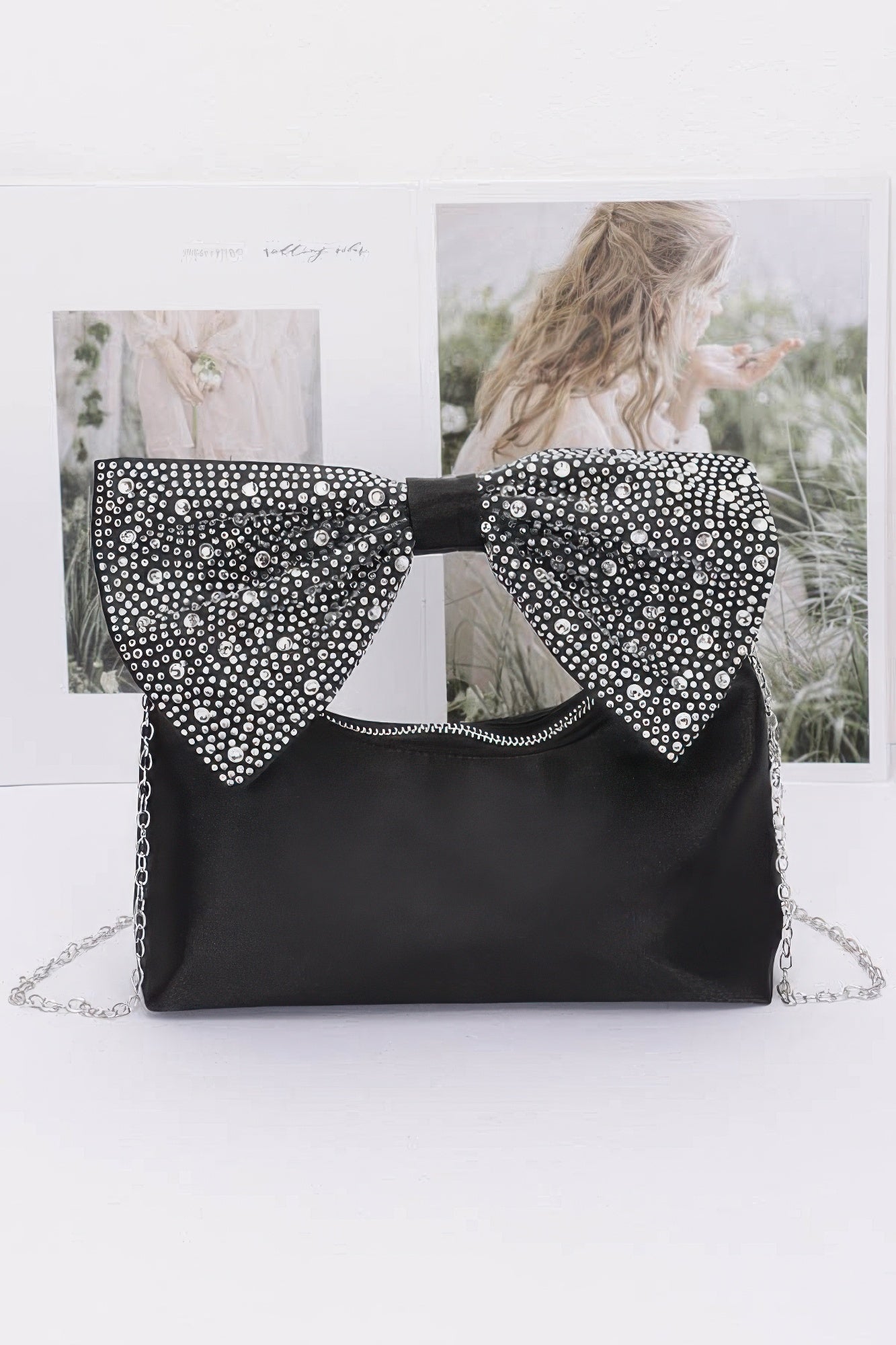 Black nylon clutch with rhinestone bow handle and silver chain strap